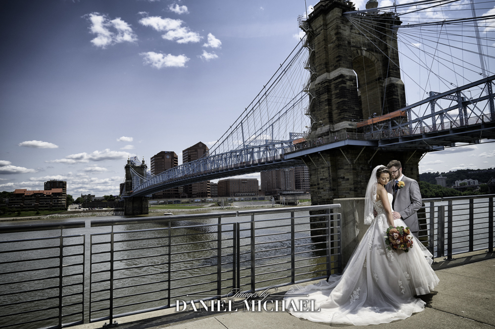 Couple in front of river and bridge